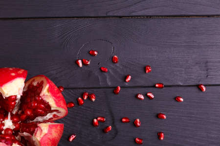A top view of a red garnet. Healthy sour pomegranate on a black background.の写真素材