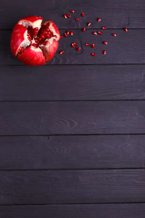 A top view of a red garnet. Healthy sour pomegranate on a black background. A garnet piece full of juicy, fresh, tasty seeds.の写真素材