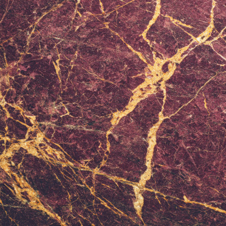 Close-up of deep burgundy marble with intricate golden veins, textured and polishedの素材