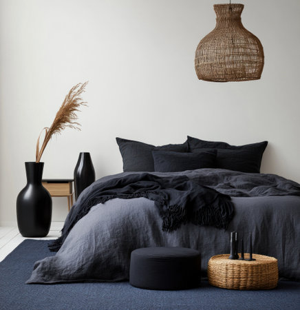 A bedroom with black vases, a wooden bed, and a white floor in a Scandinavian style. A dark blue carpet covers the ground. The walls are white. A dark gray blanket is laid out flat on one side of the duvet cover. Black round boxes lie next to it. On top, there's an elegant hanging lamp made from rattan fabric. The room also has two small tables placed at both ends of the bed. --ar 29:30 --v 6.1 Job ID: 4c4c072d-9391-4c9f-888b-d45bbfa392c6の素材