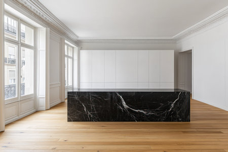 A modern apartment in Switzerland, with white walls and a wood floor. The open kitchen features a black marble countertop. Large windows on the left side of the room overlook nearby buildings, allowing in bright daylight. The photo is taken from across the living area, focusing on an empty white built-in cabinet along one wall. --ar 3:2 --v 6.1 Job ID: 68841468-a4ec-4f8d-b29a-af76d92c397fの素材