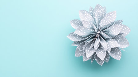 A model of an origami structure made from paper, with its edges lined in a gray color and the surface covered by white dots, is shown against a light blue background. The composition includes a top view of the design, which features multiple triangular shapes that create intricate patterns on one side while leaving space for text or graphics at the other end. This design could be used as inspiration to emphasize geometric forms through modern graphic elements or lighting effects. --chaos 30 --ar 16:9 --v 6.1 Job ID: 0716b045-e1ce-4125-b0c1-f06609a1d3f4の素材