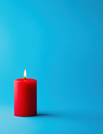 A red candle is burning on the left side of an isolated blue background, which creates light and warmth in its surroundings. The candle has a simple shape with no decorations or designs on it. It stands tall against the solid color backdrop, adding depth to the composition. This scene symbolizes simplicity, calmness, a cozy ambiance, and inspiration for illustrations and product photography. --ar 23:30 --v 6.1 Job ID: 1662de26-0612-47c1-86f3-ee34ad58a3e0の素材