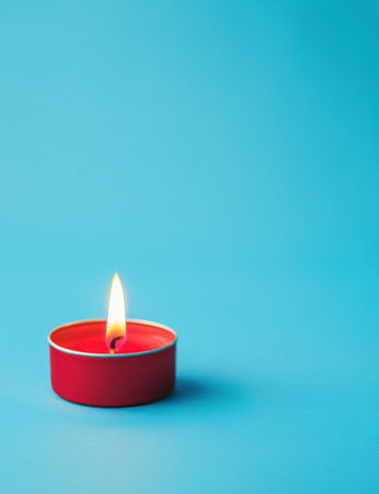 A red candle is burning on the left side of an isolated blue background, in a minimalist, product photography style. --ar 23:30 --v 6.1 Job ID: 87917206-b950-491e-8821-8a14ae3c1640の素材