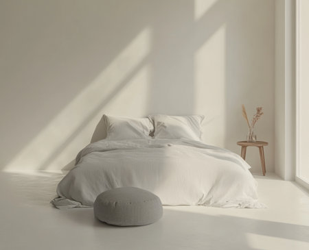 A white bedroom with a light gray bed, a gray footstool, and a small wooden bedside table. Minimalist style. Photorealistic. --ar 37:30 --v 6.1 Job ID: 610a0973-6531-4878-ad29-e17dd554f6f2の素材