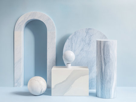 A minimal and modern scene featuring three different geometric shapes in light blue, white, and gray tones. The composition includes an arch-shaped window on the left side of the screen, a rectangular box at the center with rounded corners, and two marble columns on the right side. There is also a small circular element inside one of the walls. This design creates a clean and contemporary atmosphere, perfect for showcasing products or serving as background material for various applications. --ar 4:3 --v 6.1 Job ID: 2fe15338-7692-4c6e-9852-0e043fc772f9の素材
