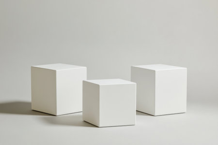3 white cube pedestals, 2 square and 1 rectangular on the floor, on a light grey background, at a 45-degree angle, front view, in a minimalist style, with simple shapes, soft lighting, high-resolution photography, professional color grading, low contrast, clean sharp focus, hyper-realistic. --ar 3:2 --v 6.1 Job ID: f8365503-4d08-4994-a282-fe3a6bb40399の素材