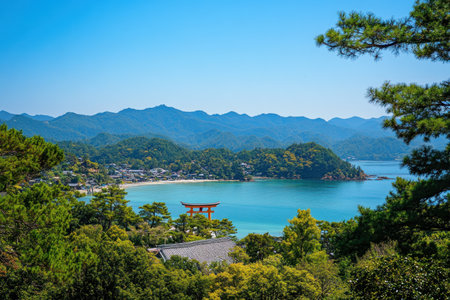 A photo of the torii gate at its center, orange in color, located on island, with pine trees and mountains in background, with sea to one side, clear blue sky, in Miyajima Japan. --ar 3:2 --v 6.1 Job ID: ad975518-1e8d-4132-ac6c-2e86f2d65900の素材