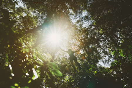 A person on an adventure park zring, walking along the balance beam high in tree tops, surrounded by lush greenery and tall trees under bright sunlight. The focus is sharp on their face as they cheer with joy while navigating through various challenges such as monkey bars or swings. Shot from below using Canon EF 24-70mm f/5 L IS USM lens at ISO160 for clarity and detail --ar 3:2 --v 6.1 Job ID: 85bac2c2-ece3-4c64-a596-2cf420d1e0ccの素材