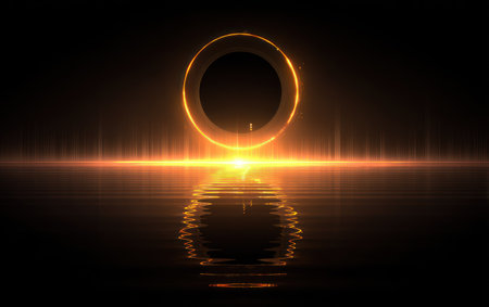 Glowing golden ring with light beams reflecting on water against a dark backdropの素材