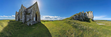 Panoramic view of the church and cliff in Ãtretat, France, with a blue sky and green grassland. --ar 3:1 --v 6.1 Job ID: a366ae11-35ec-42bc-ab31-cb20b0819fe8の素材