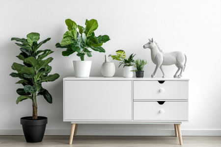 Minimalist white sideboard with plants and an animal statue, close-up on the foreground, against a clean background, perfect for adding text or design elements, professional photography. --ar 3:2 --v 6.1 Job ID: 582ee6f3-e17d-4122-9085-72917a0497e3の素材