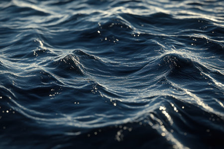A close-up of the surface texture, showing fine particles and swirls in shades of blue against the deep black water. The scene is illuminated by soft light that highlights these intricate patterns. --ar 3:2 --v 6.1 Job ID: 6e360699-fdd4-4ee6-ac3d-99b246294e7eの素材