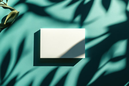 Flat lay of a blank white card on top, with a shadow overlay featuring a green and teal geometric pattern background, in a minimalist aesthetic, showcasing shadowplay. --ar 3:2 --v 6.1 Job ID: 428fdde4-5b64-48e0-b82f-35c8dee3f6e7の素材