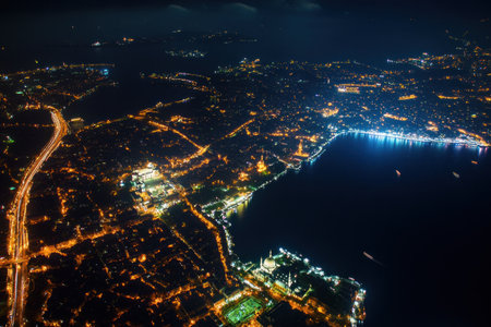 Emin Theodor, Top view of the Istanbul Bosphorus with the Blue Mosque and historical buildings illuminated at night, the city lights in front of it, the sea behind it. A photo taken from an elevated position showing all three iconic architectural landmarks of Istanbul. --ar 3:2 --v 6.1 Job ID: e7647876-9e9c-483d-aefd-5ff839349c70の素材