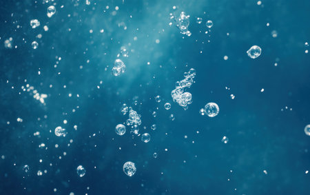 A background of bubbles floating in blue water, with a central focal point surrounded by smaller bubbles. The bubble shapes should be unique and transparent against the deep blue backdrop. This design is suitable for underwater-themed designs or backgrounds that convey a sense of tranquility and playfulness. --ar 8:5 --v 6.1 Job ID: a77148ca-47ae-44aa-880e-1e83ca121c0aの素材