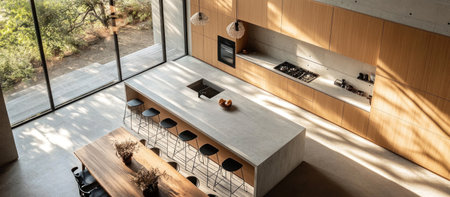 Minimalistic, aerial view of an open kitchen with a light concrete counter and wooden cabinets. A long island table has black bar stools. The background is a large window looking out to nature. --ar 16:7 --v 6.1 Job ID: cbe28127-86aa-4e26-bba2-c57c1a327b34の素材