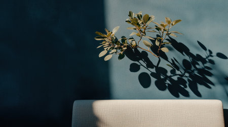 Modern gray sofa against a blue wall with a plant and its shadow in the interior design of a modern living room, a home decor idea. --chaos 30 --ar 16:9 --v 6.1 Job ID: 1a2e3a3d-0962-4b11-9024-687f62419451の素材