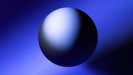 A glossy sphere, illuminated with a gradient effect, dominates the composition. The object is set against a deep blue backdrop, emphasizing its three-dimensional form. This image, with its clean lines and contrasting light, lends itself to various commercial and editorial applications, offering versatility for creative projects.の素材