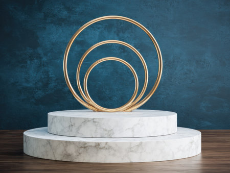 A marble podium displays golden rings in a visually striking composition. The design features layered circular forms against a textured blue background. This setup emphasizes symmetry, depth, and the interplay of light and shadow, suitable for product presentation, conceptual art, and promotional materials. The scene implies a studio setting with a clean, modern aesthetic, ideal for showcasing designs.の素材