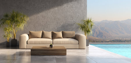An inviting living space features a beige sofa and a wooden coffee table. The scene showcases a minimalist design with natural light streaming across a concrete wall. Lush greenery and a serene swimming pool, surrounded by distant mountains, suggest an outdoor setting. Suitable for various editorial and commercial applications.の素材