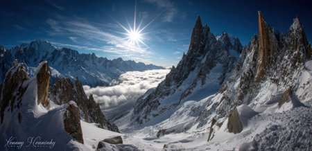 Dramatic landscape depicts snow-covered mountains with jagged peaks illuminated by a radiant sun. White snow and ice cover the rugged terrain, with a clear blue sky overhead. The composition presents a breathtaking panorama suitable for editorial and commercial applications.の素材