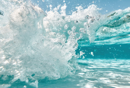 Aqua, partially submerged, shows translucent splash, droplets, and foam in an ocean settingの素材
