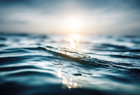 Close-up of ocean waves gently rolling under a soft sun, capturing water's surface beautyの素材