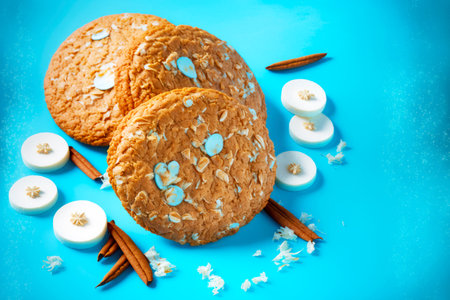 sweet delicious oatmeal cookies with coconut chips on blue background
