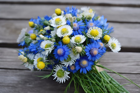 cornflower and chamomile bouquet, ready to be given as a gift, created with generative aiの素材