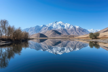serene lake with reflection of majestic mountain range and clear blue sky, created with generative aiの素材