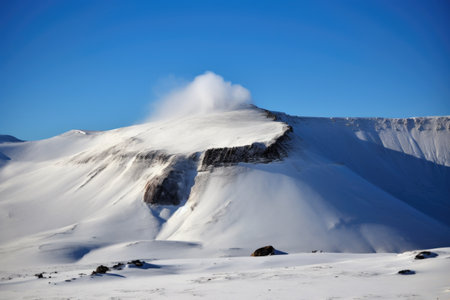dormant volcano with snow-covered summit and steam rising from the caldera, created with generative aiの素材