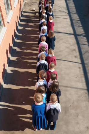 high angle shot of a group of school children standing in a row, created with generative aiの素材