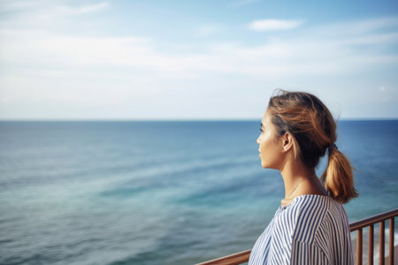 shot of a young woman looking at the sea while on vacation, created with generative aiの素材