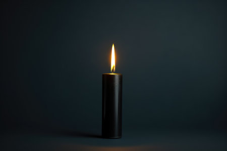 a close up shot of a black candle burning against a plain backdrop, created with generative aiの素材