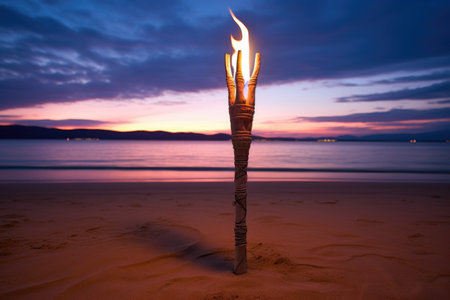a tiki torch on white sandy beach at dusk, created with generative aiの素材
