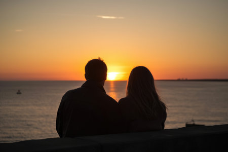 rear view shot of a young couple watching the sunset together, created with generative aiの素材