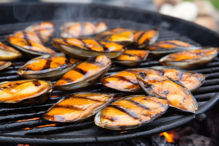 close-up of mussel shells browning on a grill, created with generative aiの素材