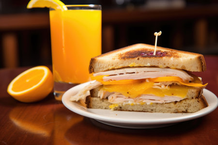 a turkey and cheese sandwich with a glass of orange juice, created with generative aiの素材