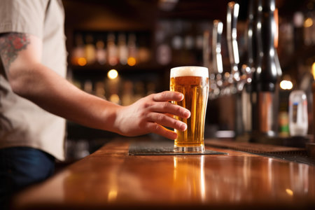 hand serving chilled pint of lager at a home bar, created with generative aiの素材