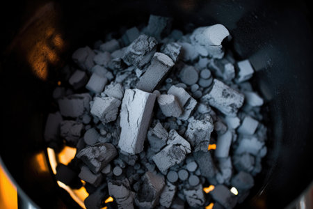 top-down view of bright charcoals in a chimney starter, created with generative aiの素材