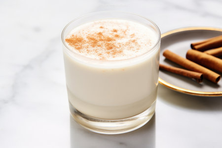 horchata with sprinkled cinnamon on a marble countertop, created with generative aiの素材