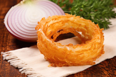 a detailed shot of a half-eaten onion ring on a napkin, created with generative aiの素材