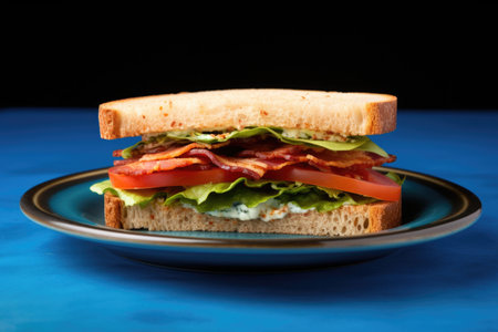 freshly made bacon sandwich on a bright blue plate, created with generative aiの素材