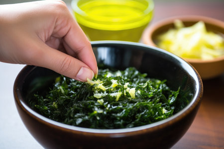 hand squeezing a lime over a bowl of seaweed salad, created with generative aiの素材