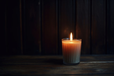 single lit candle in a dimly lit room, created with generative aiの素材