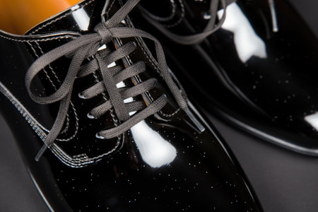 close-up of laces on a shiny leather shoe, created with generative aiの素材