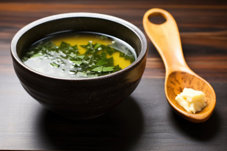miso soup in a ceramic bowl with a wooden soup spoon, created with generative aiの素材