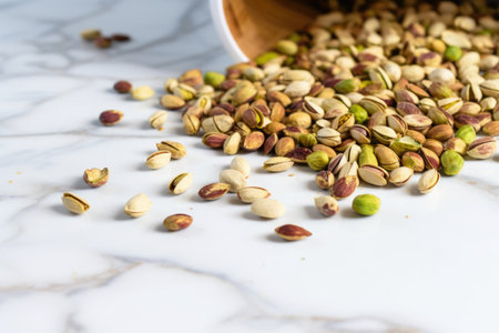pistachios scattered on a faux marble kitchen countertop, created with generative aiの素材