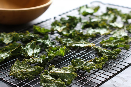 freshly baked kale chips on a cooling rack, created with generative aiの素材